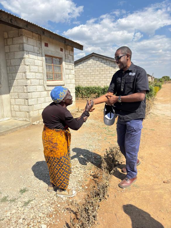 KABWE, ZAMBIA (2025) Board Chair, Mulenga Muleba, tours Habitat  Zambia’s active projects and greets homeowner, Rosemary. 