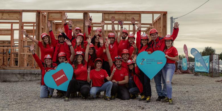 Volunteers on a construction site posing for a photo in Romania