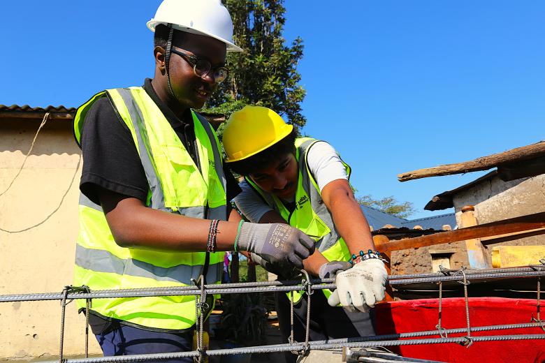 two volunteers working at a build site