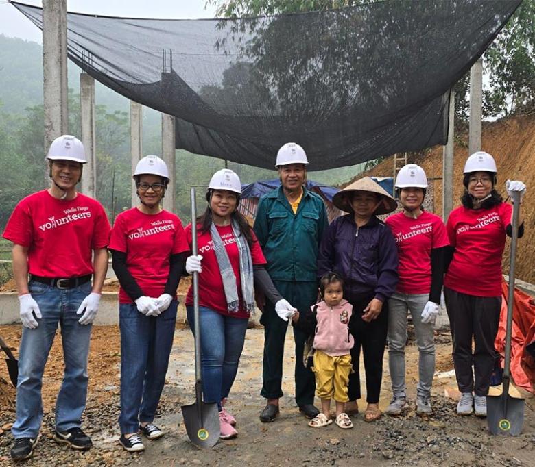 Linh (third from left) with Wells Fargo Vietnam volunteers and local community