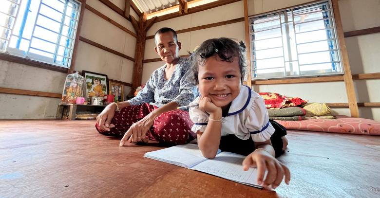 Lem poses for a portrait with her granddaughter, Chanya, inside the house in Siem Reap, Cambodia.