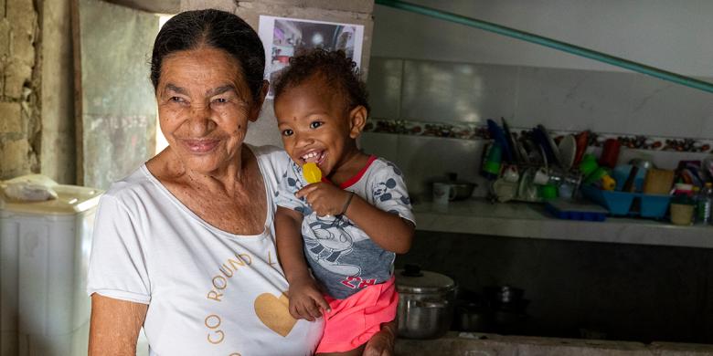 Isabel María arrived in the Olaya Herrera neighborhood in Cartagena 33 years ago after being displaced by violence. Through her own effort she acquired her home and, after separating, took on the upbringing of her two children and two grandchildren. Today she feels at peace seeing her grandson crawl safely on the new concrete floor installed thanks to 100 Thousand Floors to Play. © Habitat for Humanity International / David Estrada