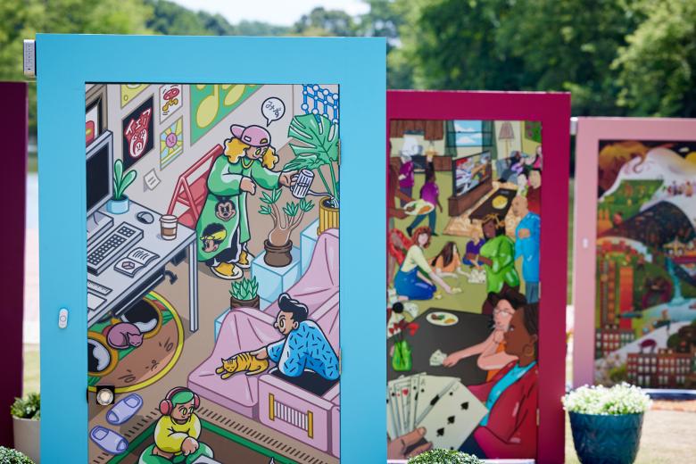 Three doors in doorframes appear staggered with art illustrated on the front of each.