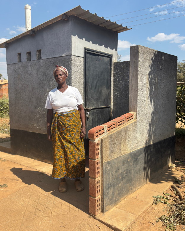 A woman stands infront of a bathroom