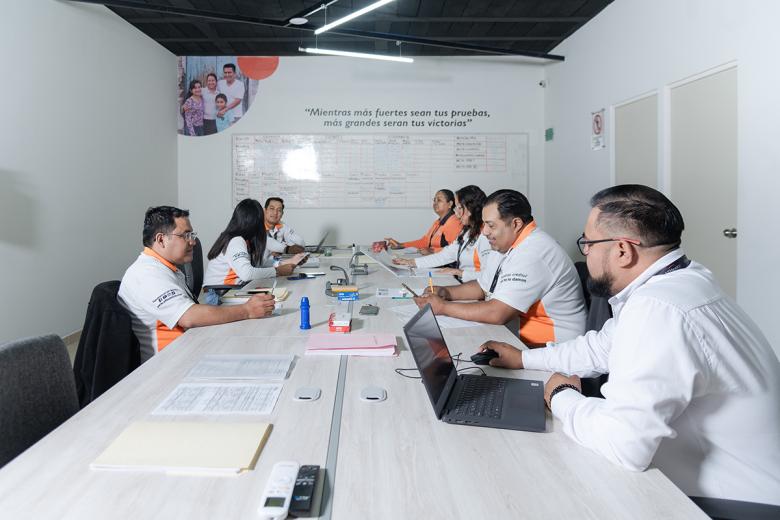 VisionFund Mexico loan officers prepare for field visits at the Córdoba, Veracruz branch, which has pioneered the promotion and disbursement of housing loans.