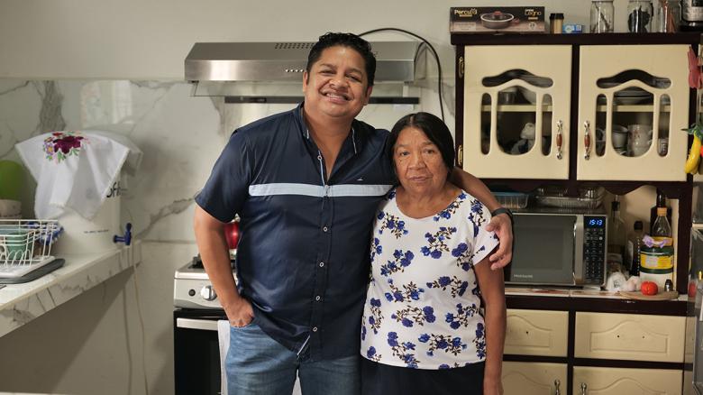 Juan Pablo and his mother, María del Carmen, in the kitchen of their new home.