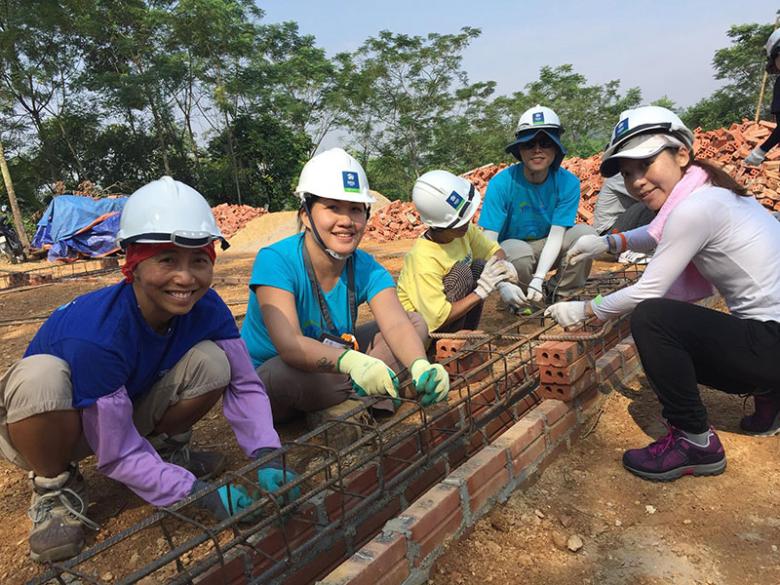 Olivia Wong with volunteers and future homeowner at a build in Batam, Indonesia